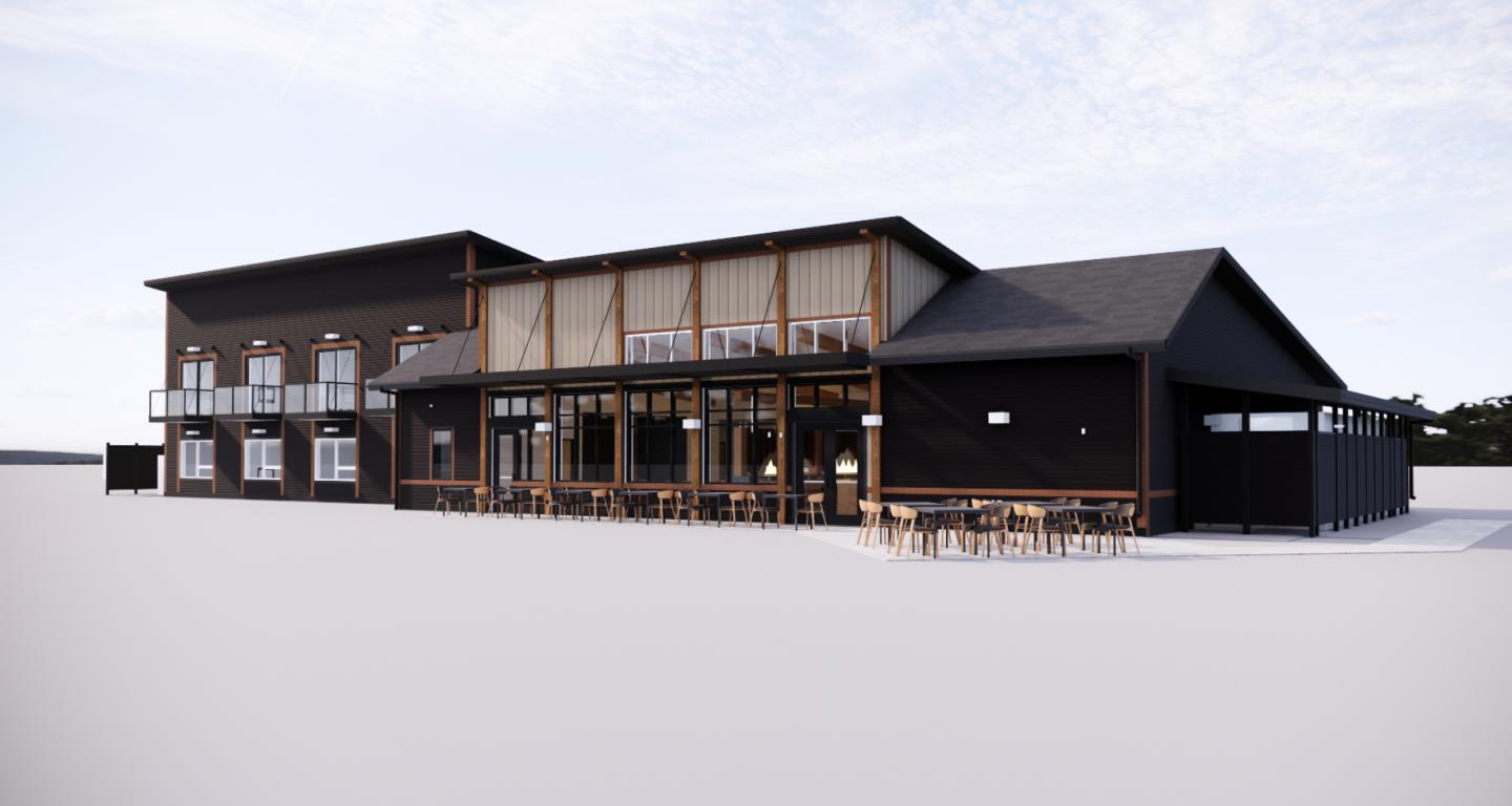 Modern two-story building with a wood and glass exterior, outdoor tables.