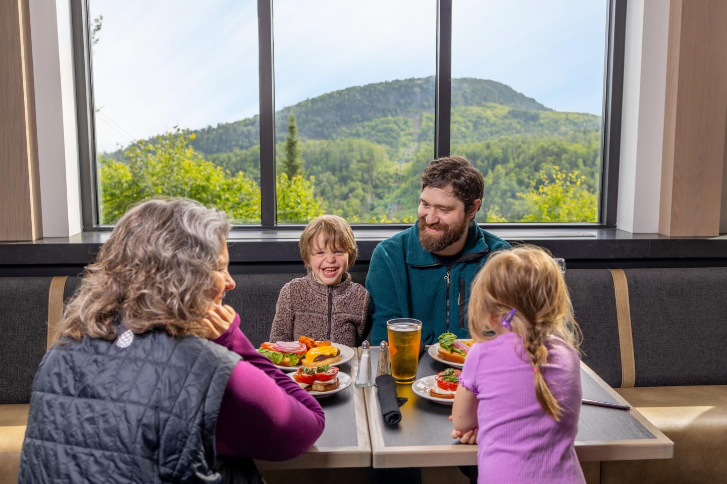 Family dining with mountain view in background.