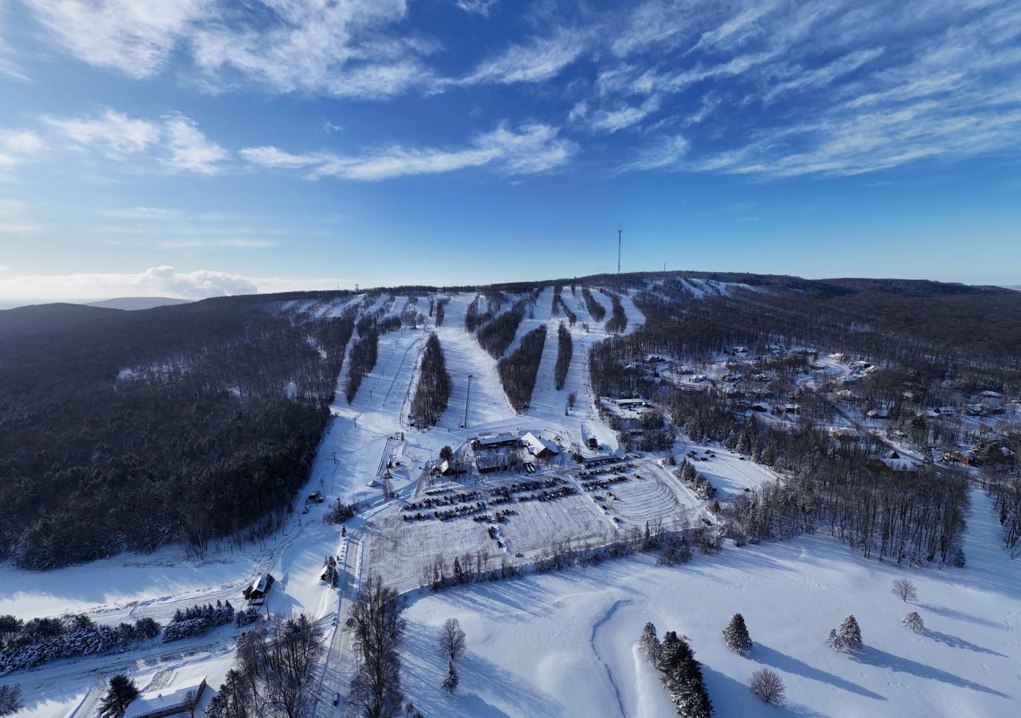 Snow-covered ski resort under a clear blue sky.