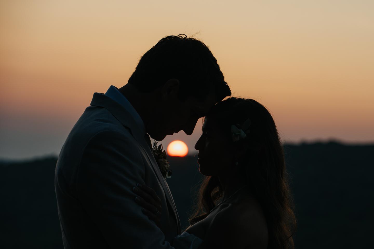 Silhouette of a couple embracing at sunset.