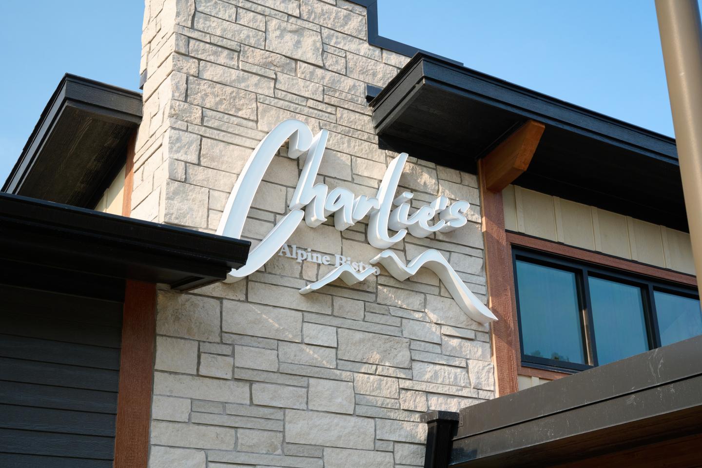 Stone building facade with modern signage.